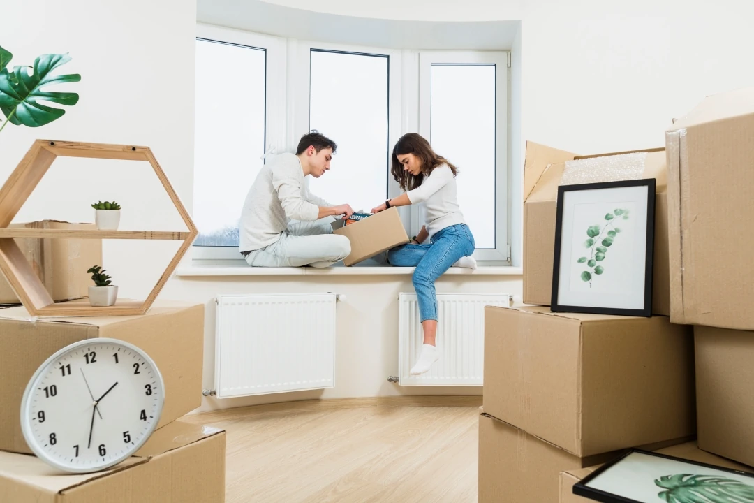 A family overseeing the loading of their belongings into a moving truck